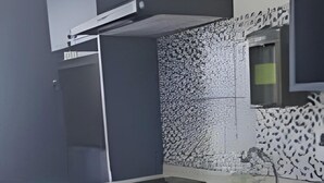 A modern kitchen with a built-in sink, a microwave, and a small refrigerator. - Studios Expo Stay  (São Paulo)