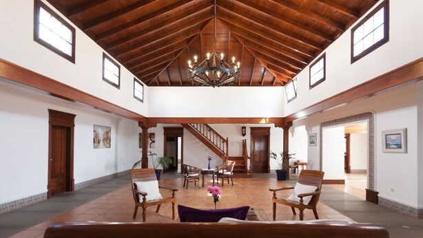 A spacious lobby with a high wooden ceiling, a chandelier, and a staircase leading to upper floors. - Bellavista private heated pool and sauna (Valles, Los)
