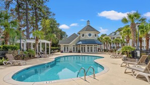A swimming pool with lounge chairs, a covered pavilion, and a large building with a dome and circular windows. - Stylish Myrtle Beach Retreat, Golf Views • Pool • Near Beach and Broadway (Myrtle Beach)