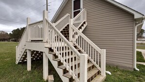 A two-story building with a wooden staircase and a small window. - A Little Country w/ A Little Beach (BOLIVIA)