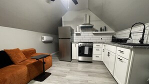 A compact kitchen with white cabinets, a built-in oven, and a refrigerator. - A Little Country w/ A Little Beach (BOLIVIA)