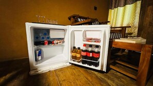 An open refrigerator with beverages and condiments. - Ama Eco Lodge (WPRH+9G Sigiriya)
