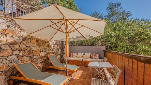 A wooden deck with lounge chairs, a table, and an umbrella. - GRIMAUD – BEAUTIFUL PROVENCAL VILLA IN THE HEART OF THE VILLAGE (GRIMAUD)