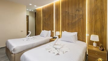 Habitación triple Confort | Ropa de cama