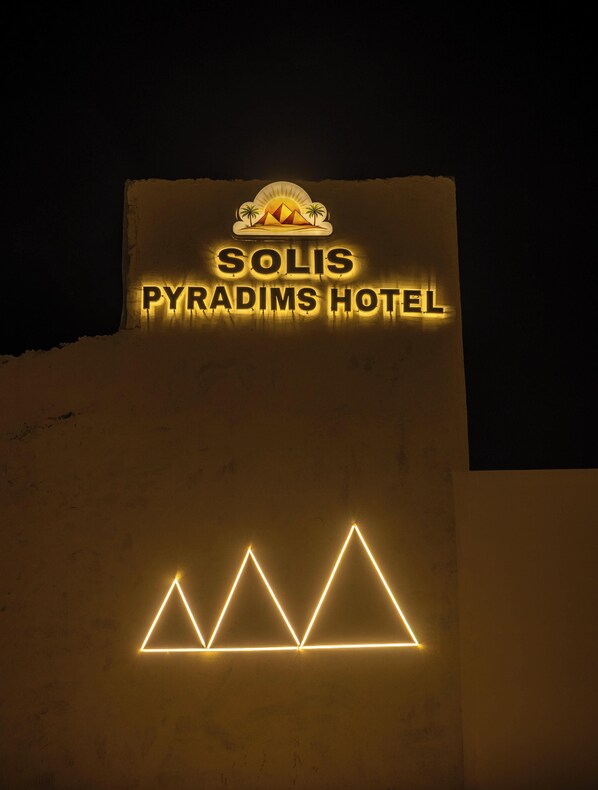 A hotel sign with the name 'Solis Pyramids Hotel' and a logo above it. - Solis pyramids view hotel (Giza)