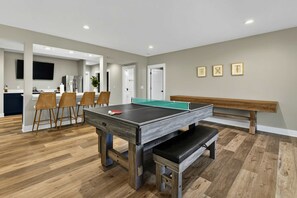 Game Room Angle - Pool table center stage with bar seating and the shuffleboard just behind. - Lakefront Lake Anna, Boat Dock, Hot Tub, Movie Theatre (Bumpass)