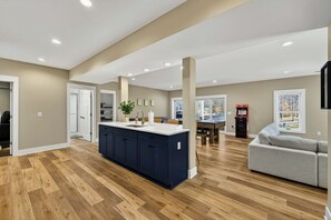 Game Room Layout - The open lower level connects the navy kitchen island, bar seating, and game area all in one space. - Lakefront Lake Anna, Boat Dock, Hot Tub, Movie Theatre (Bumpass)