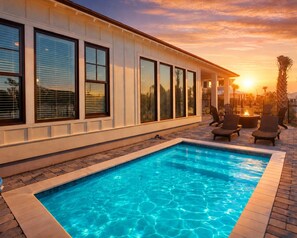 A swimming pool with a patio area, large windows, and a sunset view. - New! Private Pool, Walk To Beach, Water View, 5 Star Amenities, Lux 4BR, Firepit (Gulf Shores)