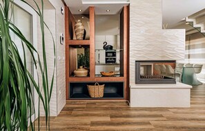 A modern interior with a wooden shelving unit, a woven basket, and a sleek kitchen area. - Holiday Home Villa Anabel (Kaštelir)