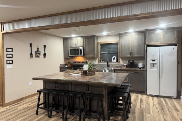 Kitchen w/ a nice sized island that seats 8. Kuerig coffee pot. Coffee provided.