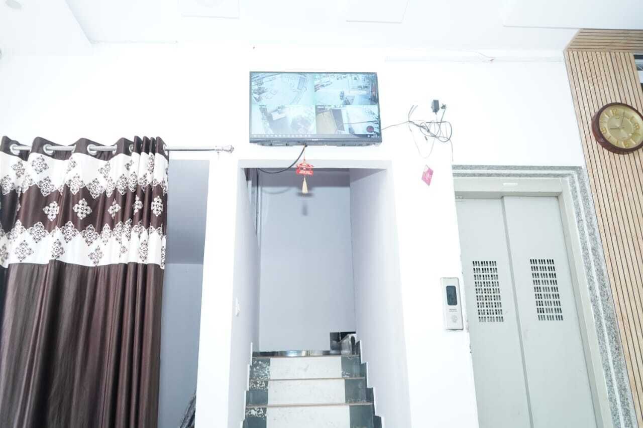A staircase leading to a room with a television mounted above it.