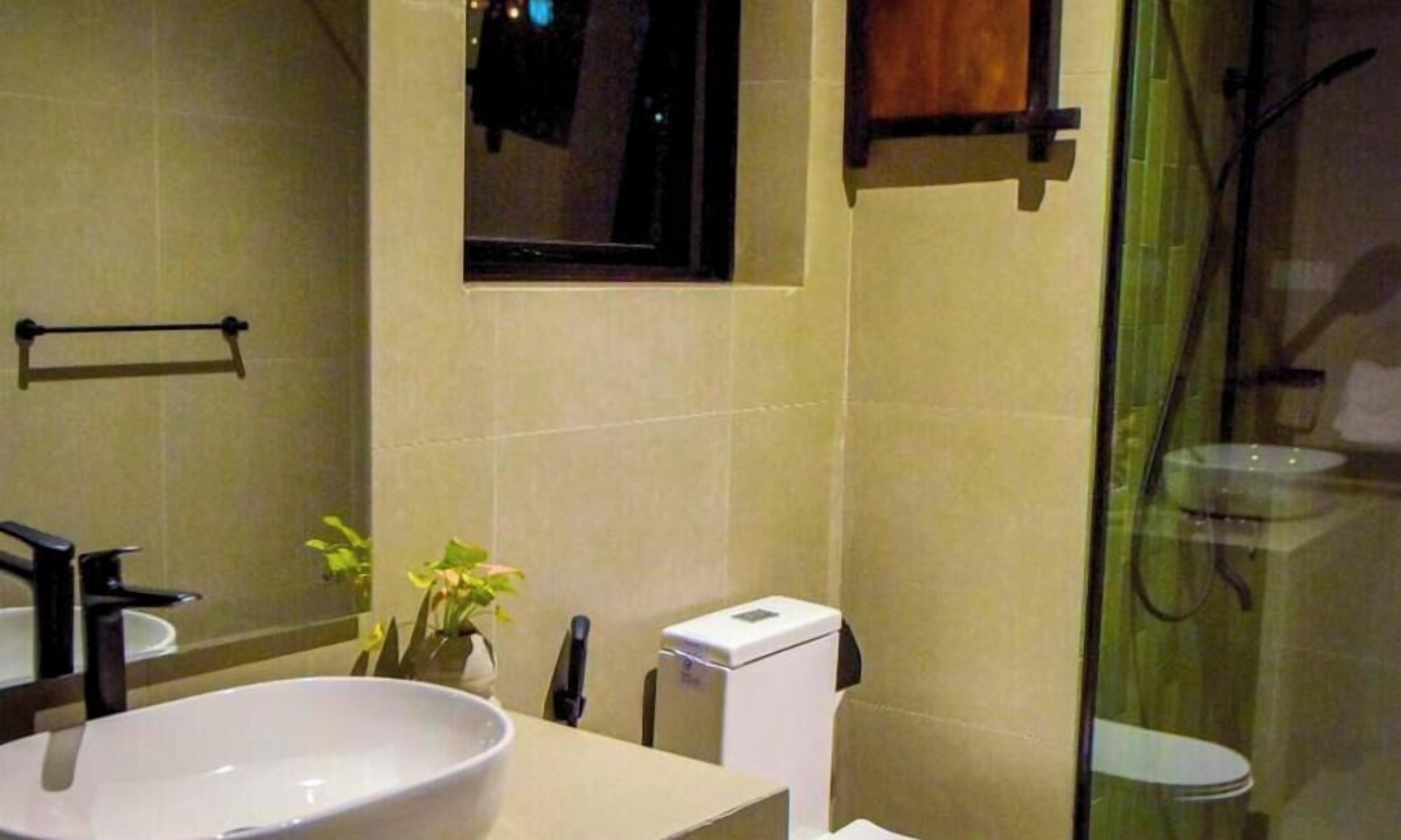 A bathroom with a sink, mirror, towel rack, and a small window.