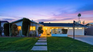 A residential house with a well-maintained lawn, a driveway, and a garage. - Private Pool + Firepit + Ping Pong + Expansive Backyard | Mins to Dining (Scottsdale)