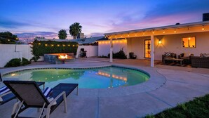A swimming pool with lounge chairs, a fire pit, and outdoor seating. - Private Pool + Firepit + Ping Pong + Expansive Backyard | Mins to Dining (Scottsdale)