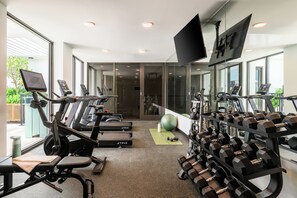 A gym with treadmills, dumbbells, and exercise balls. - Sleeps 18 | 3 Suites + Rooftop Pool + Fitness Center | Near Wynwood | Sense28 (Miami)