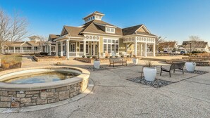 A hotel with a covered patio, outdoor seating, and a stone fountain. - 4 Mi to Boardwalk! Bethany Beach Getaway (Millville)