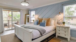 A bedroom with a bed, nightstands, a window with blinds, a ceiling fan, and a view of the outdoors. - Disney Magic & Resort Fun! Family Gem in Davenport (Davenport)