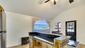 A kitchen with a wooden island, a refrigerator, and a door with a window. - 3 Mi to Sabine River: East Texas Cabin Hideaway (Joaquin)