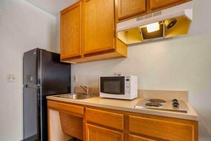 Fridge, microwave, stovetop, dining tables