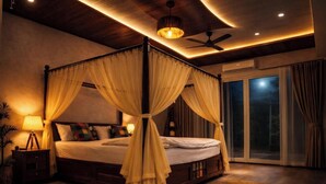 A four-poster bed with a canopy, a ceiling fan, and a nightstand with a lamp. - The Golden View Farm & Resort (Sonkach)