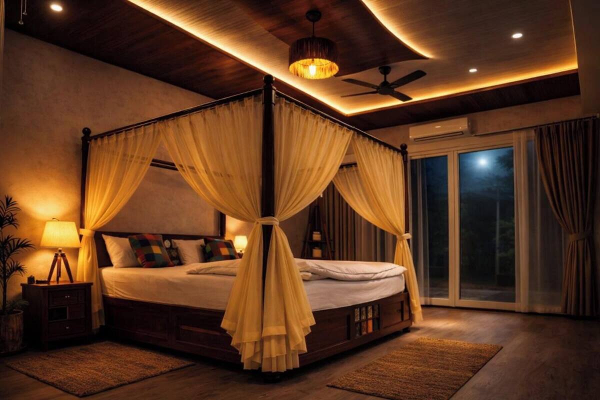 Un lit à baldaquin avec quatre poteaux, un ventilateur de plafond et une table de chevet avec une lampe.