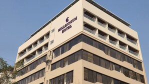 Un edificio de hotel de varios pisos con un cartel llamativo que dice 'Millennium Hotel'.
