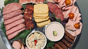 A platter of assorted meats, cheeses, and dips. - Chateau D'Amour Luxury Boutique (Bucharest)