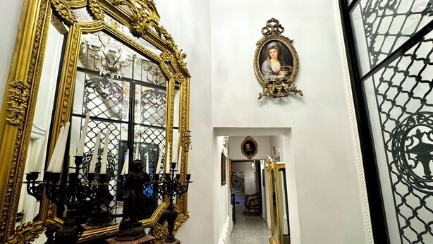 A hallway with ornate mirrors, a clock, and a portrait on the wall. - Chateau D'Amour Luxury Boutique (Bucharest)