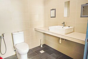 A bathroom with a toilet, a sink, and a shower.