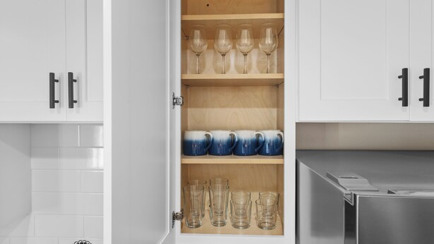 A kitchen cabinet with shelves containing wine glasses, mugs, and clear drinking glasses. - Desert Rose Retreat in the Heart of Downtown PHX (Phoenix)