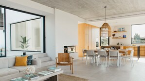 Un salon moderne avec un canapé, une table basse et un coin repas.