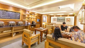 A restaurant with wooden furniture, a chalkboard menu, and various food and drink dispensers. - 14 LUXE By Mums Home (Kathmandu)