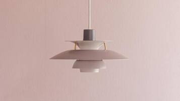 A pendant light fixture with a minimalist design, hanging from a ceiling.