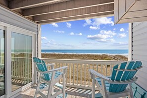 A balcony with two chairs overlooking a beach. - Dog Friendly-Sandy Dunes-Sleeps 6-3br/2b-Oceanfront-WIFI (North Myrtle Beach)