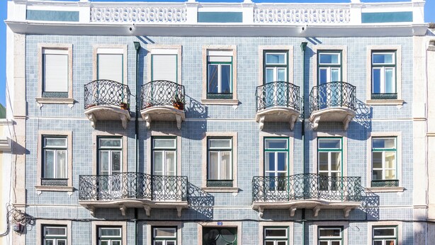 A multi-story building with balconies, each with ornate wrought iron railings. - Rooftop Apartment with Private Terrace (Lisboa)