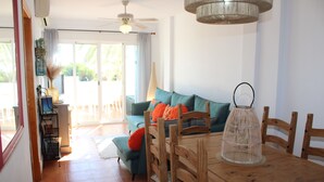 Ein Essbereich mit Holztisch, Stühlen und Deckenventilator.
