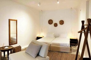 A hotel room with two beds, a sitting area, a mirror, and a ladder. - Patron 1 Pool Sunset Villa- Seven Bedrooms (Mikonos)