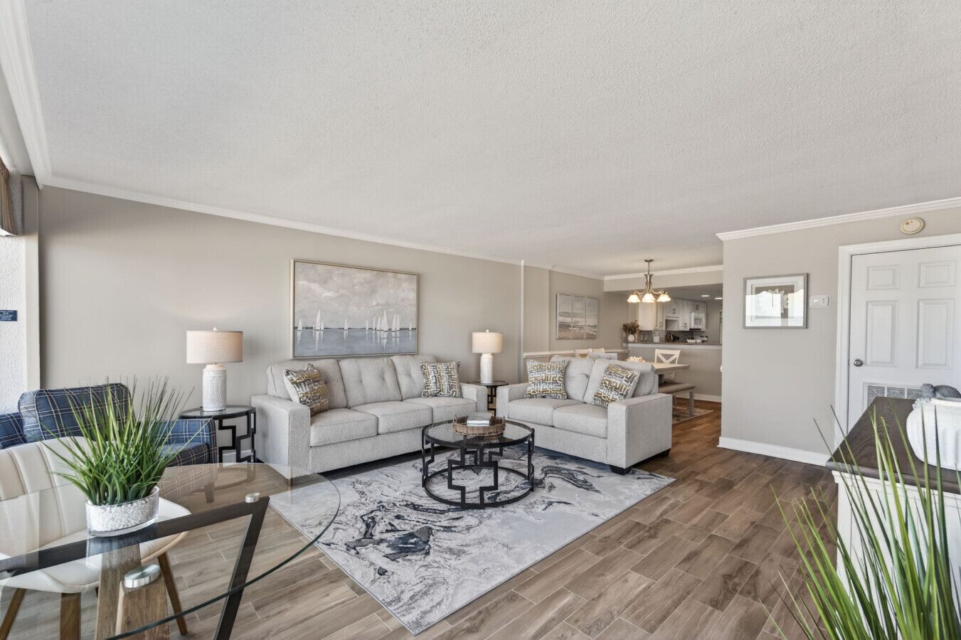 A modern living room with a sofa, coffee table, and dining area.