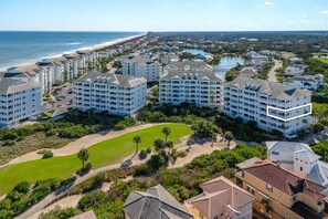 A coastal resort with multiple hotel buildings, a golf course, and a beach. - Corner Condo #141 with Ocean & Golf Course Views at Cinnamon Beach (Palm Coast)