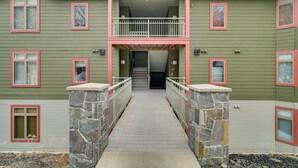 A multi-story building with a central staircase leading to a balcony. - Direct Trail Access: Resort-style Killington Gem (Killington)