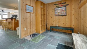 A wooden-paneled room with a bench, a shelf, a door, and a doormat. - Direct Trail Access: Resort-style Killington Gem (Killington)