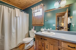 A bathroom with a wooden vanity, a white sink, and a toilet. - Family Lake Days! Mtn-view Cabin in Hiawassee (Hiawassee)