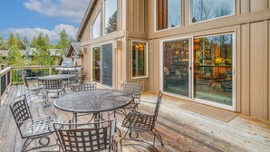 A deck with outdoor furniture, a grill, and large sliding glass doors. - Luxury Sunriver Vacation Rental, Hot Tub, A/C, SHARC (Sunriver)