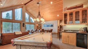 A pool table, wooden cabinets, a bar area, and a seating area with a view. - Luxury Sunriver Vacation Rental, Hot Tub, A/C, SHARC (Sunriver)