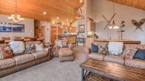 A spacious living area with leather sofas, a wooden coffee table, and a pool table. - Luxury Sunriver Vacation Rental, Hot Tub, A/C, SHARC (Sunriver)