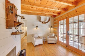 A wooden interior with two white armchairs, a wooden ceiling, and a deer skull on the wall. - 'peace of Aska' Cabin w/ Hot Tub & Fire Pit! (Blue Ridge)