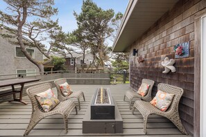 Outdoor dining - Luxury coastal home with ocean views, deck, and artful interiors. Mid-term rental, 30+ nights. (Manzanita)