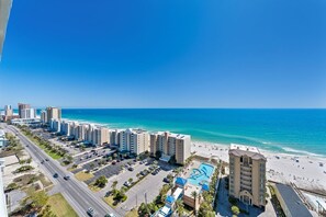 A coastal hotel with multiple buildings, a parking lot, and a beach. - Gulf Shores Condo | Direct Beach Access | Sleeps 6 (Gulf Shores)