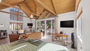 A spacious room with a large bed, a desk, a chair, and a television. - Desert Escape With Private Balcony Condo (Indian Wells)