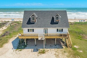 A two-story house with a balcony, located near a beach with ocean views. - The Shoreline Social - Front Row Beach Home, Cheers! (Surfside Beach)
